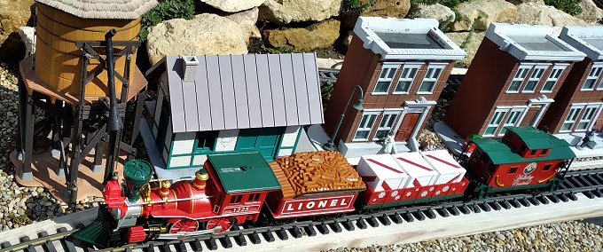 A 2012ish Lionel battery-powered General and its train on an outdoor railroad with mostly 1:24 accessories.  Click for bigger photo.